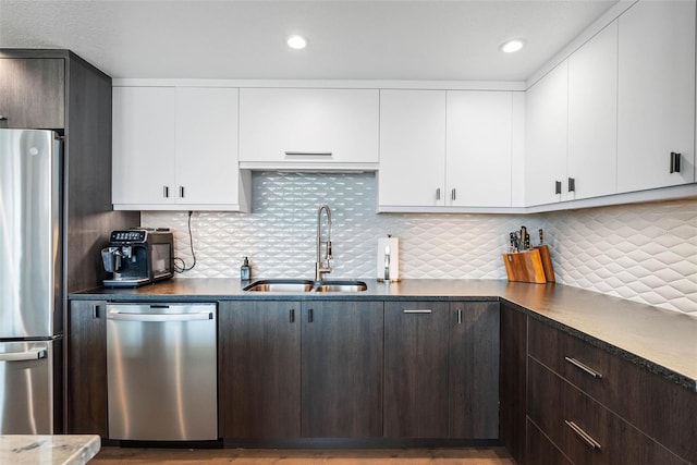 kitchen with sink, decorative backsplash, dark brown cabinetry, and stainless steel appliances