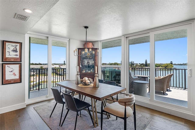 sunroom / solarium with a water view