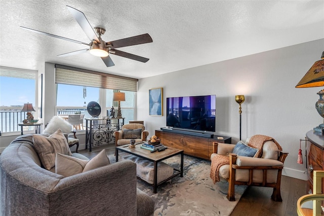 living room featuring a textured ceiling, hardwood / wood-style flooring, and ceiling fan