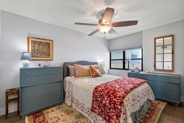 bedroom featuring dark wood-type flooring and ceiling fan