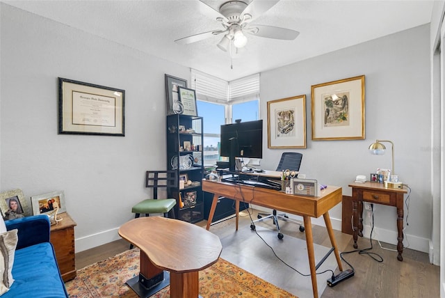 office space featuring ceiling fan and wood-type flooring