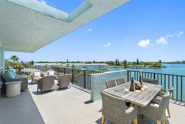 view of patio featuring a balcony and a water view