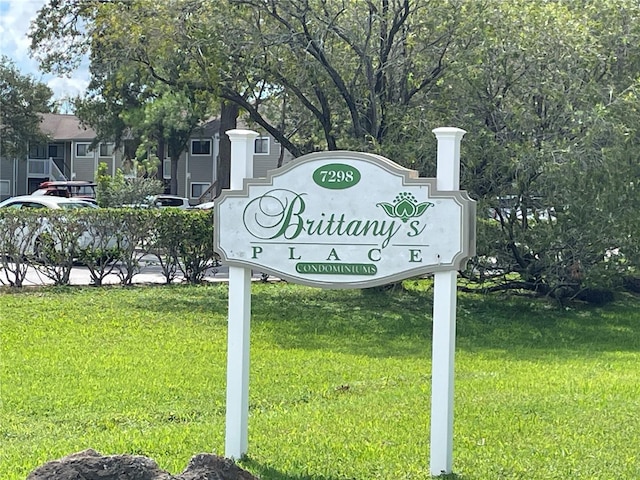 community sign featuring a lawn