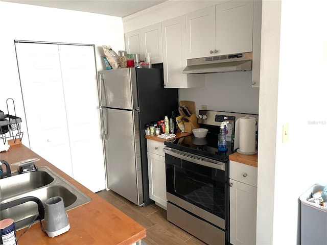 kitchen with white cabinets, appliances with stainless steel finishes, and sink