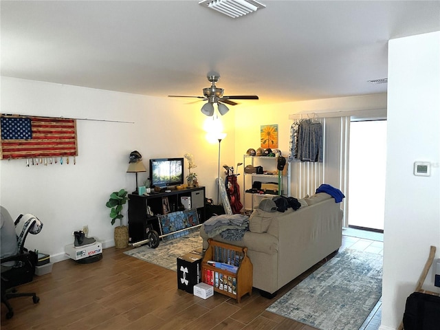 living room featuring dark hardwood / wood-style flooring and ceiling fan