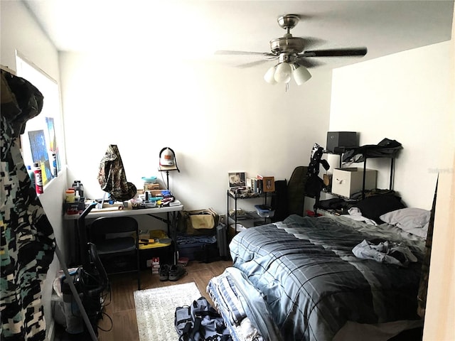 bedroom with dark hardwood / wood-style floors and ceiling fan