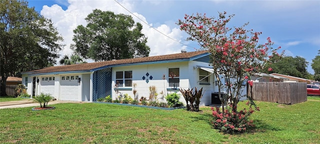 view of front facade with a front yard and a garage