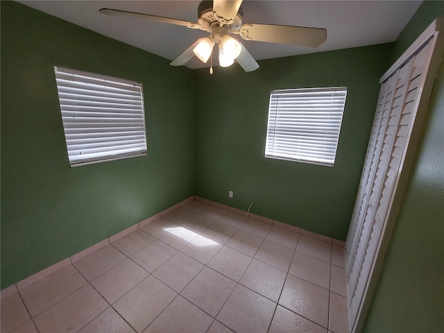 spare room with light tile floors and ceiling fan