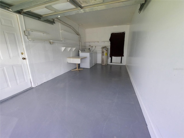 garage featuring water heater and independent washer and dryer