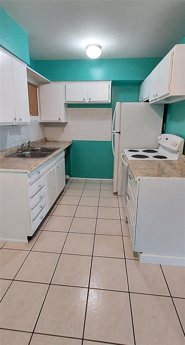 kitchen with white cabinets, light tile flooring, white electric range oven, and sink