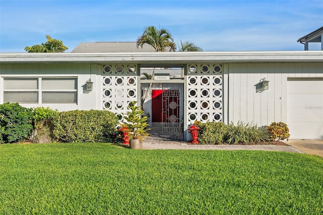 single story home with a garage and a front lawn