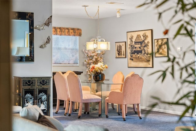 dining area with carpet and a textured ceiling