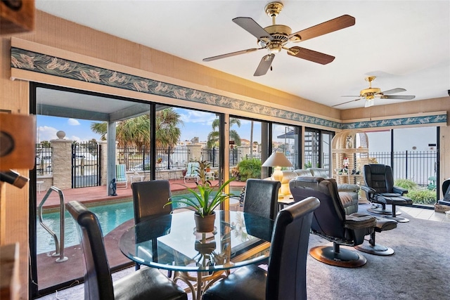 sunroom / solarium featuring ceiling fan