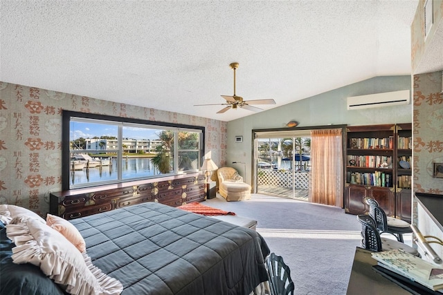 carpeted bedroom featuring ceiling fan, a textured ceiling, a water view, a wall mounted AC, and lofted ceiling