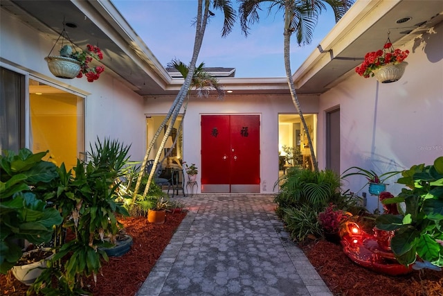 view of exterior entry at dusk