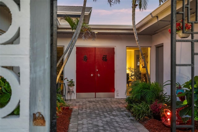 view of exterior entry at dusk