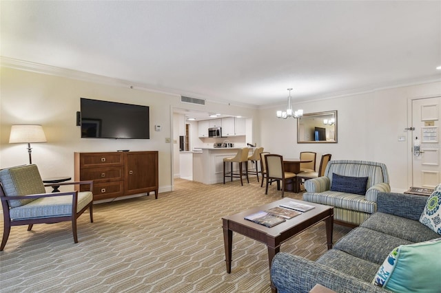 carpeted living room with ornamental molding and an inviting chandelier