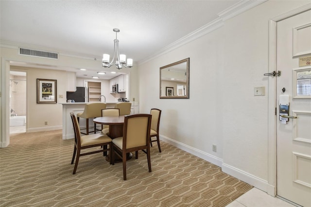 tiled dining room featuring crown molding, an inviting chandelier, and sink