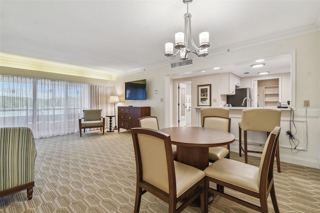 carpeted dining area featuring an inviting chandelier and ornamental molding