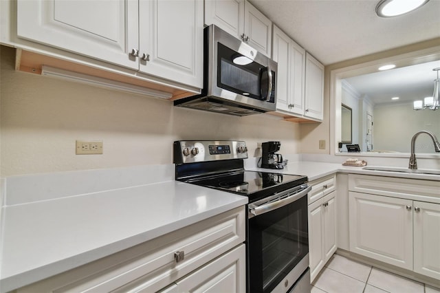 kitchen with white cabinetry, a notable chandelier, and appliances with stainless steel finishes