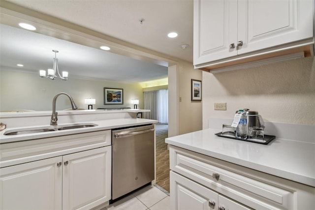 kitchen featuring pendant lighting, sink, dishwasher, a notable chandelier, and white cabinetry