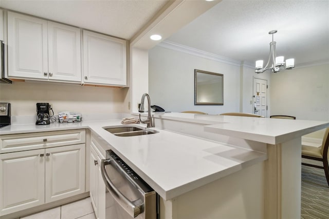 kitchen with sink, hanging light fixtures, white cabinets, a chandelier, and stainless steel dishwasher