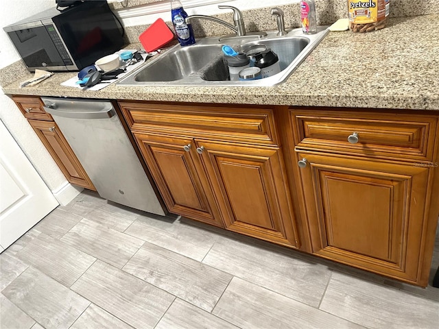 interior space with light tile floors, sink, and stainless steel appliances