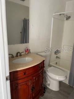 full bathroom with toilet, vanity, and tub / shower combination