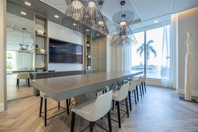 dining room featuring hardwood / wood-style floors and an inviting chandelier