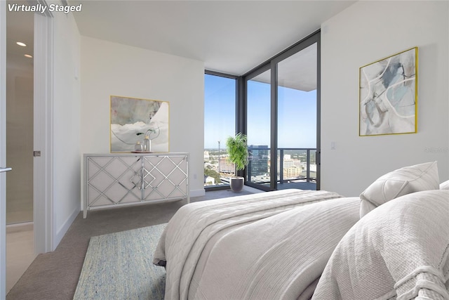 carpeted bedroom featuring access to exterior and a wall of windows