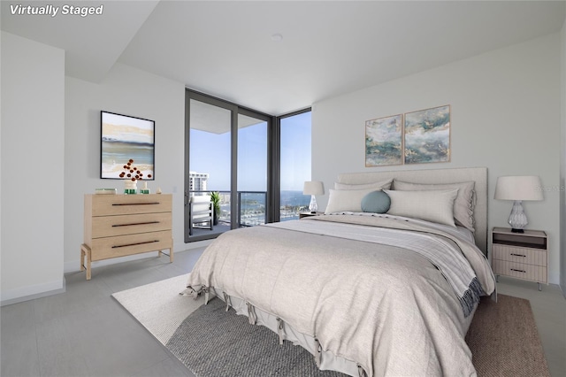 bedroom featuring floor to ceiling windows and access to exterior