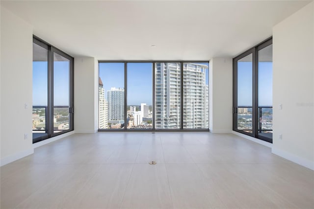 tiled empty room with floor to ceiling windows