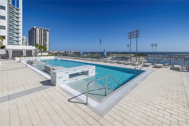 view of pool featuring a patio and a hot tub