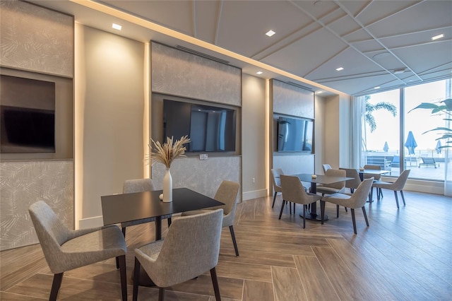 dining room featuring a wall of windows and parquet floors