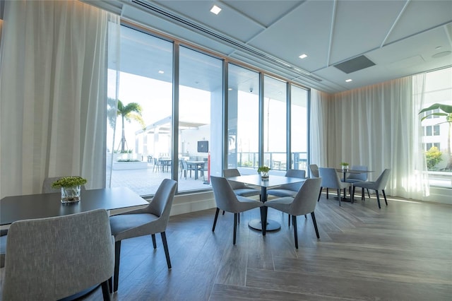 dining space with a wall of windows and a wealth of natural light