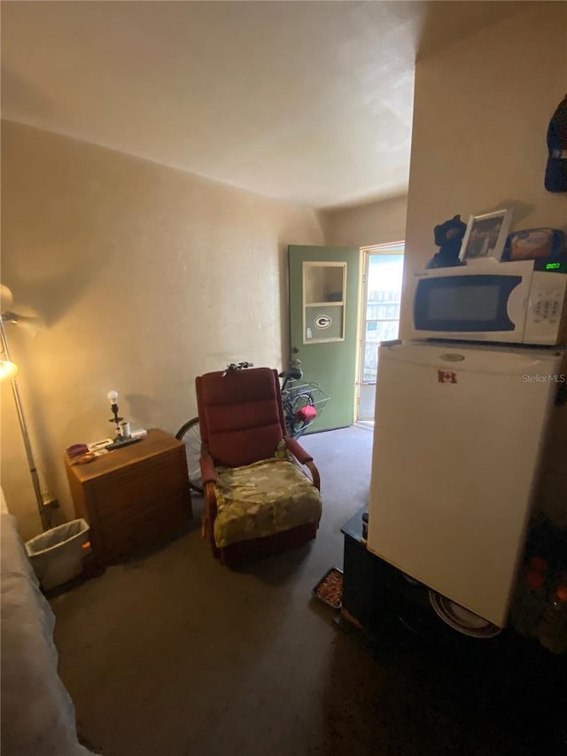 carpeted bedroom featuring fridge