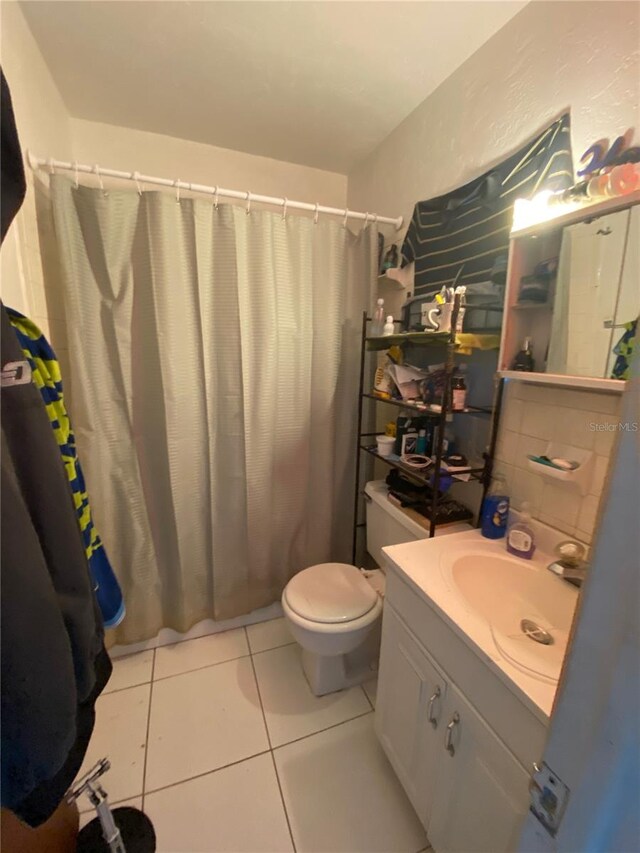 bathroom featuring large vanity, tile floors, and toilet