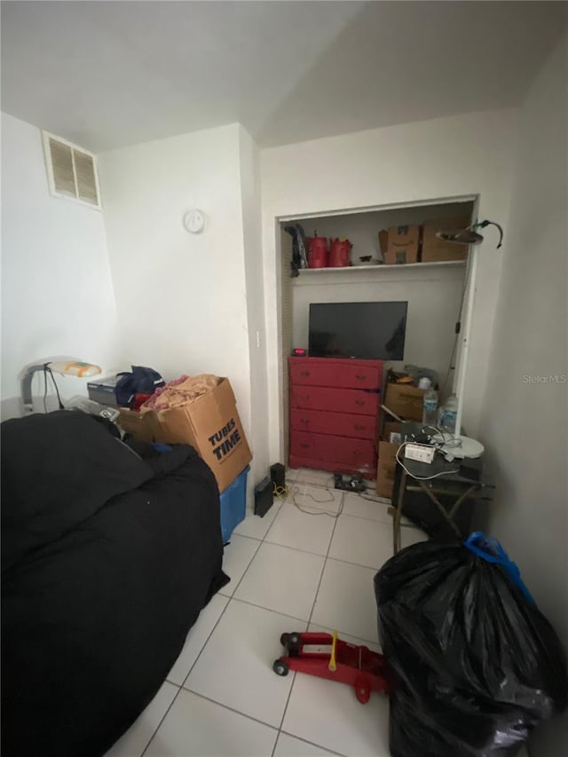 bedroom featuring light tile floors