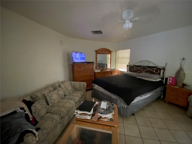 tiled bedroom with ceiling fan