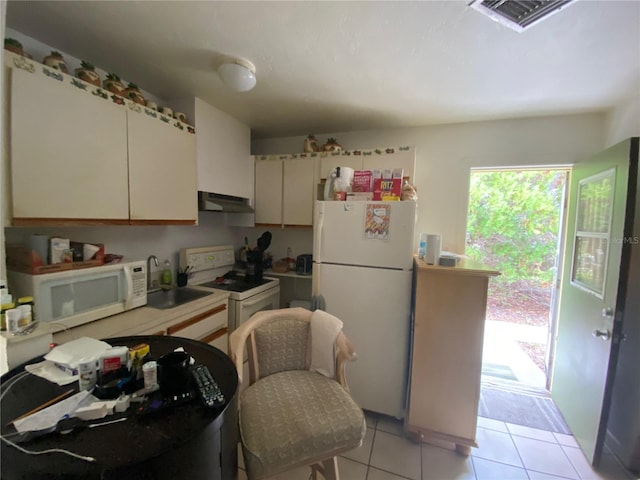 kitchen featuring light tile flooring, sink, and white appliances