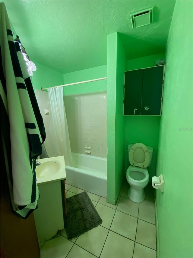 full bathroom featuring tile flooring, toilet, vanity, shower / bath combination with curtain, and a textured ceiling