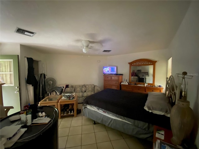 bedroom featuring light tile floors and ceiling fan