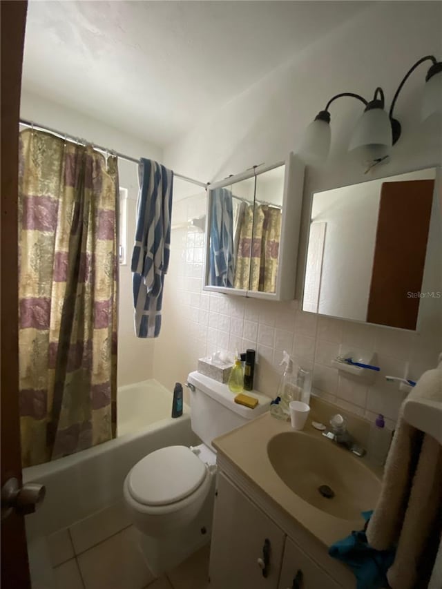 full bathroom featuring toilet, large vanity, shower / bathtub combination with curtain, backsplash, and tile floors