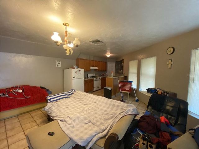 bedroom with a notable chandelier, white refrigerator, and light tile floors