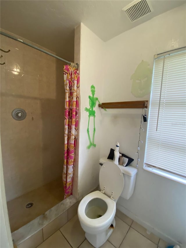 bathroom with tile flooring, toilet, and a shower with shower curtain