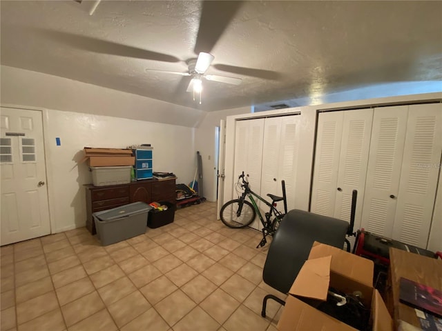 tiled office space featuring ceiling fan