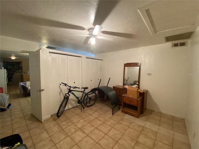 tiled home office featuring ceiling fan