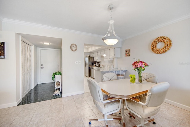 tiled dining room with sink and crown molding