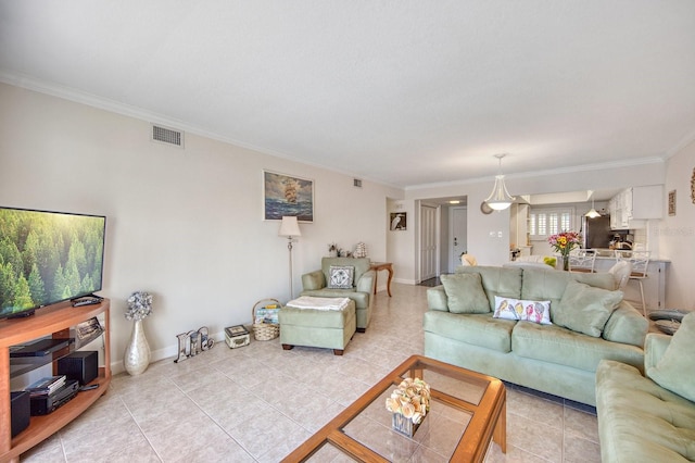 living room featuring light tile patterned floors and crown molding