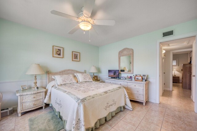 tiled bedroom with ceiling fan